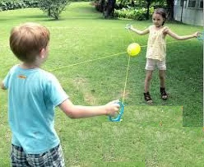 this photo shows two children playing with a Zoom ball. Their arms are wide open and their shoulders are retracted while their heads and backs are straight.